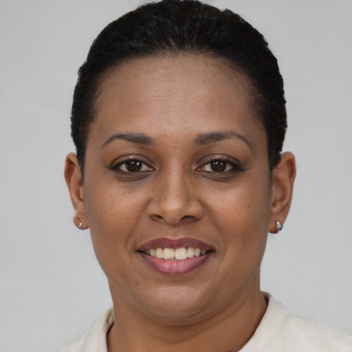 Joyful black young-adult female with short  brown hair and brown eyes