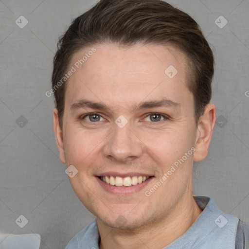 Joyful white young-adult male with short  brown hair and grey eyes