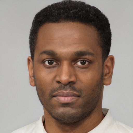 Neutral black young-adult male with short  black hair and brown eyes