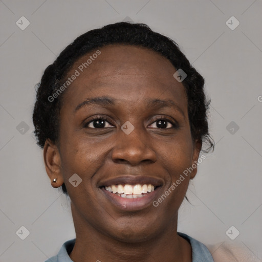 Joyful black young-adult female with short  black hair and brown eyes