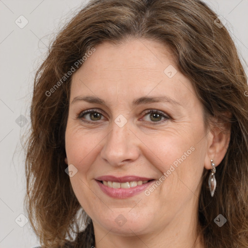 Joyful white adult female with long  brown hair and brown eyes