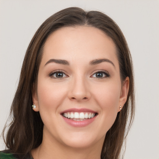 Joyful white young-adult female with long  brown hair and grey eyes