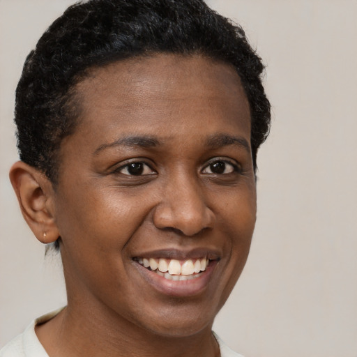 Joyful black young-adult female with short  brown hair and brown eyes