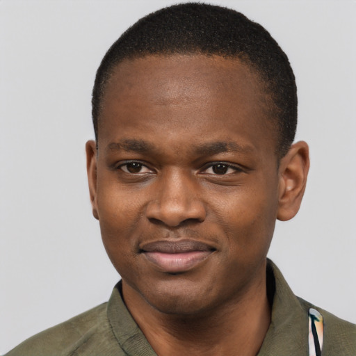 Joyful latino young-adult male with short  brown hair and brown eyes