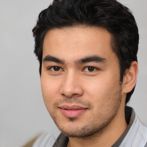 Joyful asian young-adult male with short  black hair and brown eyes