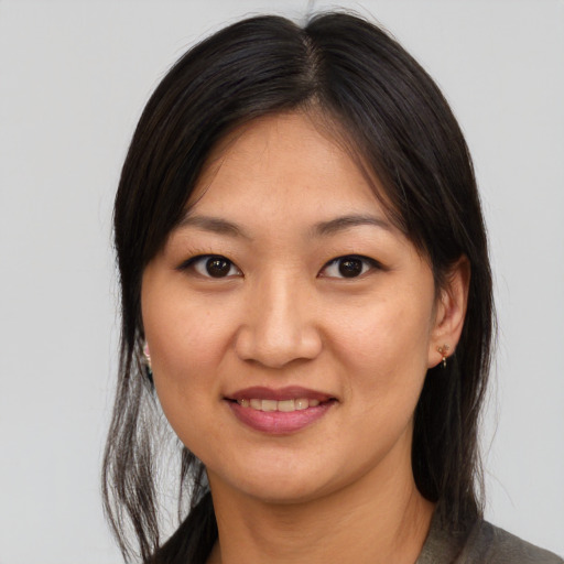 Joyful asian young-adult female with medium  brown hair and brown eyes