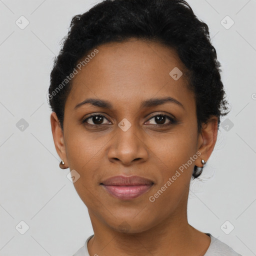 Joyful black young-adult female with short  black hair and brown eyes