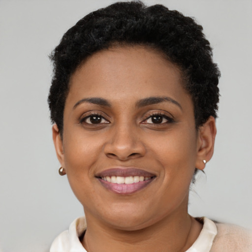 Joyful latino young-adult female with short  brown hair and brown eyes