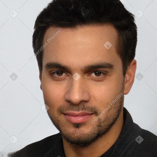 Joyful white young-adult male with short  black hair and brown eyes