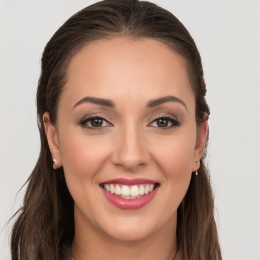 Joyful white young-adult female with long  brown hair and grey eyes