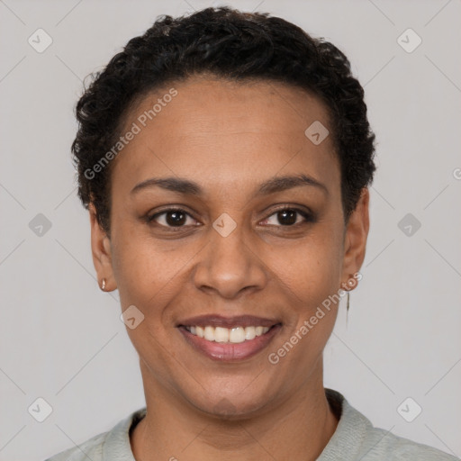 Joyful black young-adult female with short  black hair and brown eyes