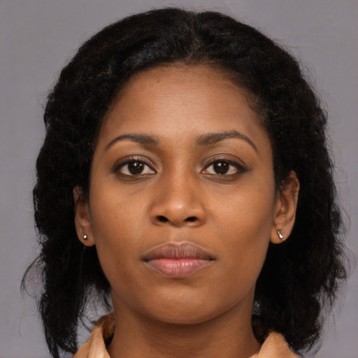 Neutral black young-adult female with long  brown hair and brown eyes