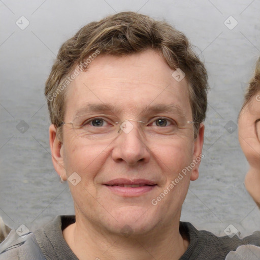 Joyful white adult male with short  brown hair and grey eyes