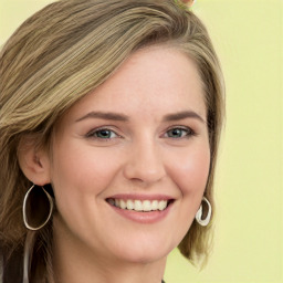 Joyful white young-adult female with long  brown hair and green eyes