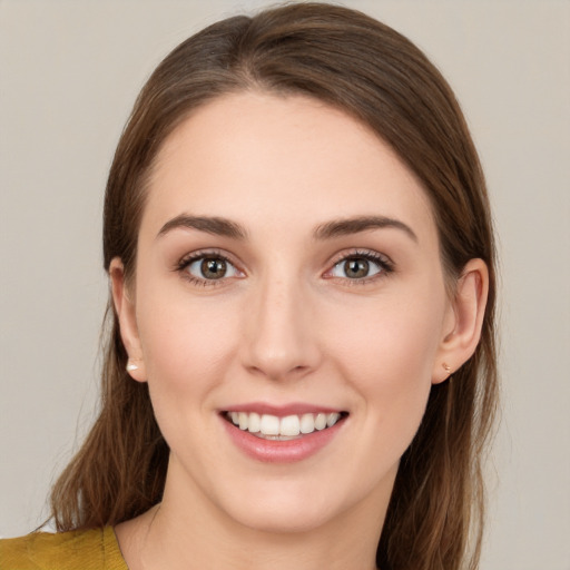 Joyful white young-adult female with medium  brown hair and green eyes