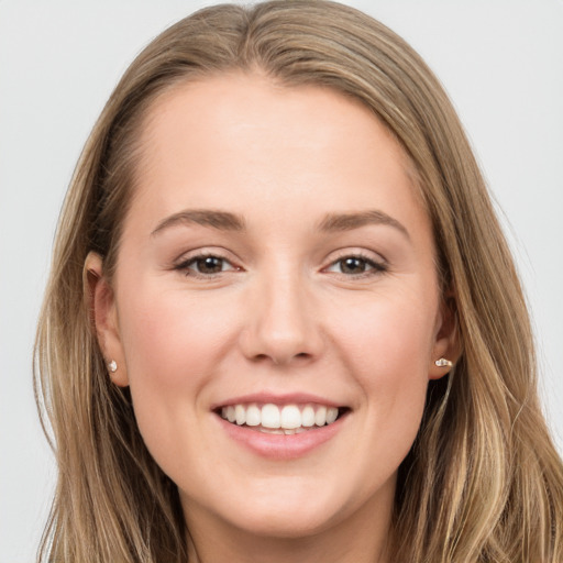 Joyful white young-adult female with long  brown hair and grey eyes