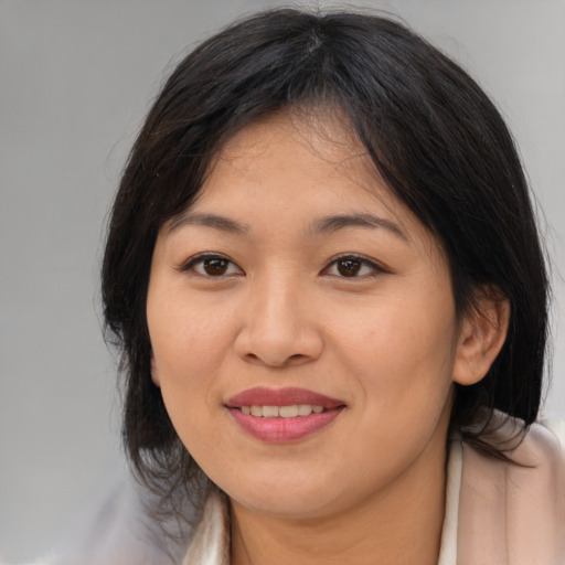 Joyful asian young-adult female with medium  brown hair and brown eyes