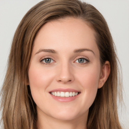 Joyful white young-adult female with long  brown hair and green eyes