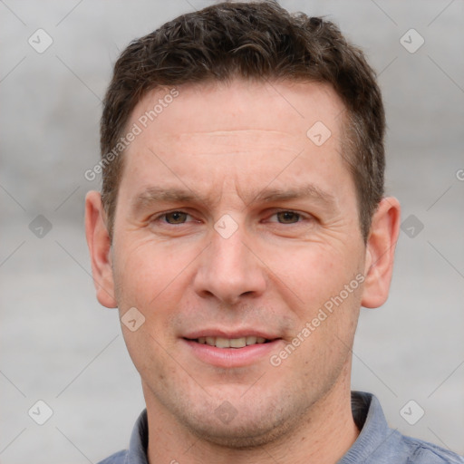 Joyful white adult male with short  brown hair and grey eyes