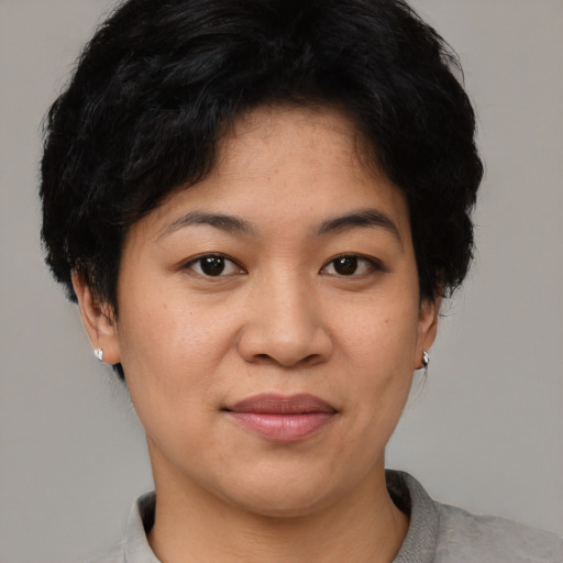 Joyful asian young-adult female with short  black hair and brown eyes