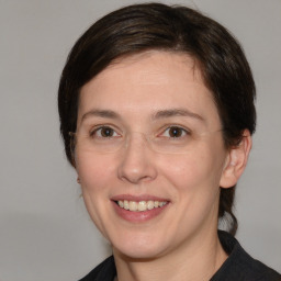 Joyful white adult female with medium  brown hair and brown eyes