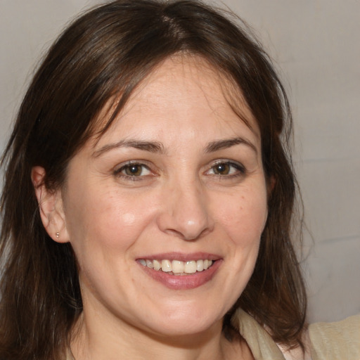 Joyful white adult female with medium  brown hair and brown eyes