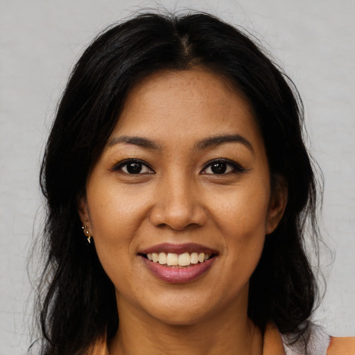 Joyful asian young-adult female with long  brown hair and brown eyes