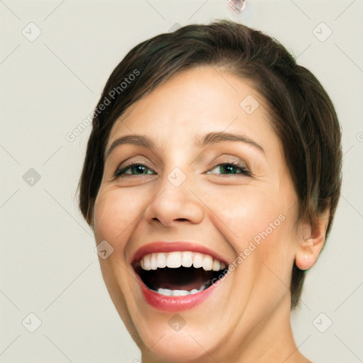 Joyful white young-adult female with medium  brown hair and green eyes