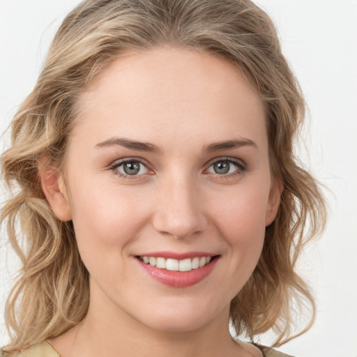 Joyful white young-adult female with medium  brown hair and green eyes