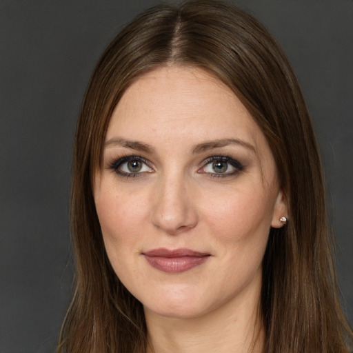 Joyful white young-adult female with long  brown hair and green eyes