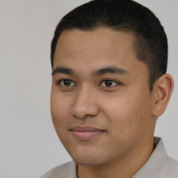 Joyful latino young-adult male with short  brown hair and brown eyes