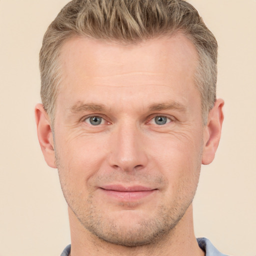 Joyful white adult male with short  brown hair and grey eyes