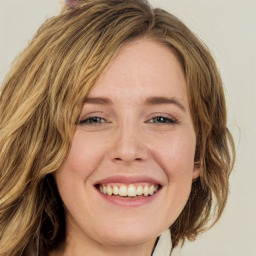 Joyful white young-adult female with long  brown hair and green eyes