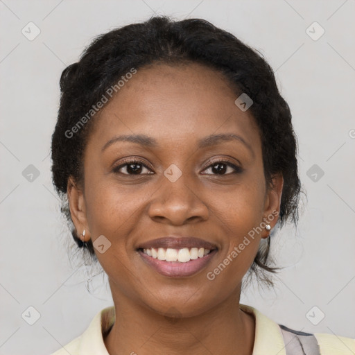 Joyful black young-adult female with short  brown hair and brown eyes