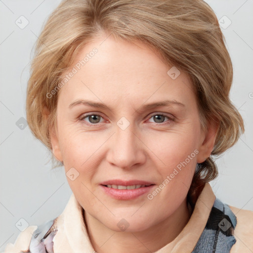 Joyful white young-adult female with medium  brown hair and blue eyes