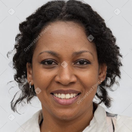 Joyful black adult female with medium  brown hair and brown eyes