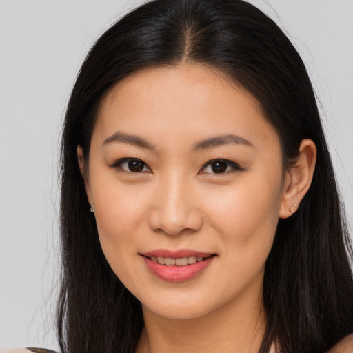 Joyful asian young-adult female with long  brown hair and brown eyes