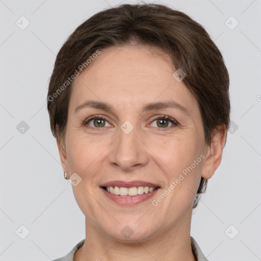 Joyful white adult female with short  brown hair and grey eyes