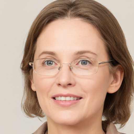 Joyful white adult female with medium  brown hair and grey eyes