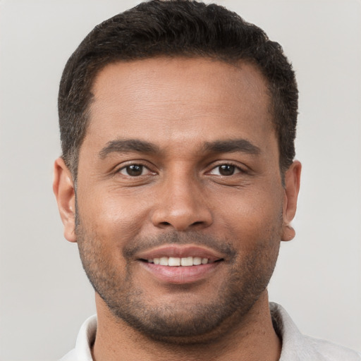 Joyful white young-adult male with short  brown hair and brown eyes