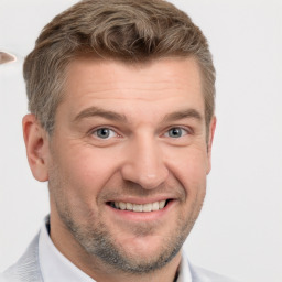 Joyful white adult male with short  brown hair and brown eyes