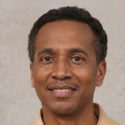 Joyful latino adult male with short  black hair and brown eyes