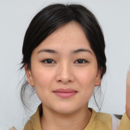 Joyful asian young-adult female with medium  black hair and brown eyes