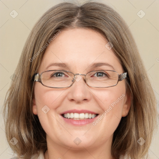 Joyful white adult female with medium  brown hair and green eyes