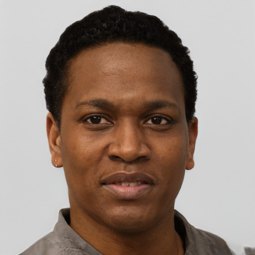 Joyful black young-adult male with short  black hair and brown eyes