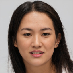 Joyful asian young-adult female with long  brown hair and brown eyes