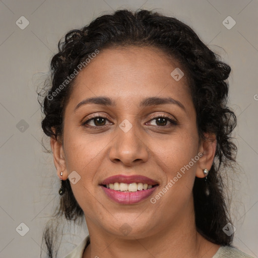 Joyful latino adult female with medium  brown hair and brown eyes