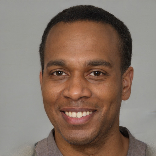 Joyful latino adult male with short  brown hair and brown eyes