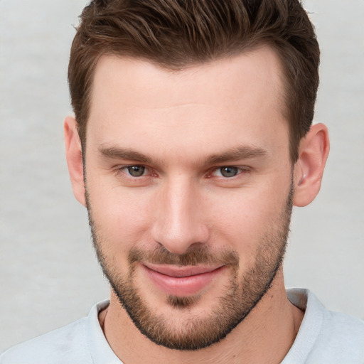 Joyful white young-adult male with short  brown hair and brown eyes