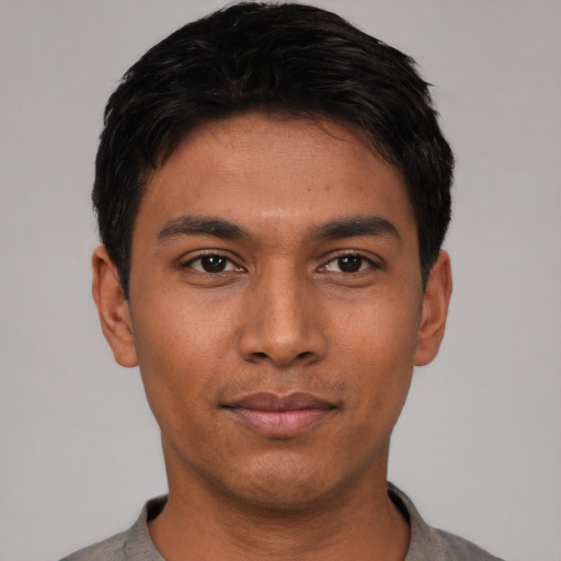 Joyful asian young-adult male with short  black hair and brown eyes